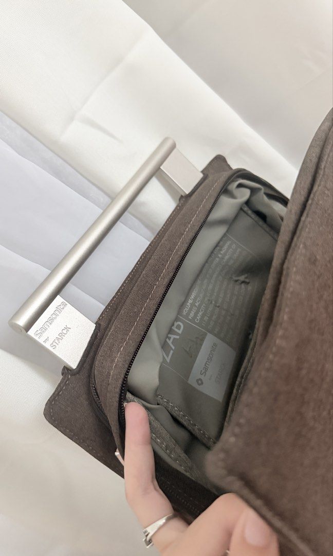 Samsonite Zab Backpack by Starck | Grayish Brown Backpack with Metal Handle (Category: Backpacks) located in Iloilo. Submitted by aislynndawn (Listing ID 1469004211, Image 3). Description: - Brand: Samsonite - Color: Grayish Brown - Features: Sturdy silver metal top handle, Compact structured rectangular shape - Storage: Spacious main compartment with multiple inner organizers and pockets - Convenience: Zippered outer pocket and dual adjustable s