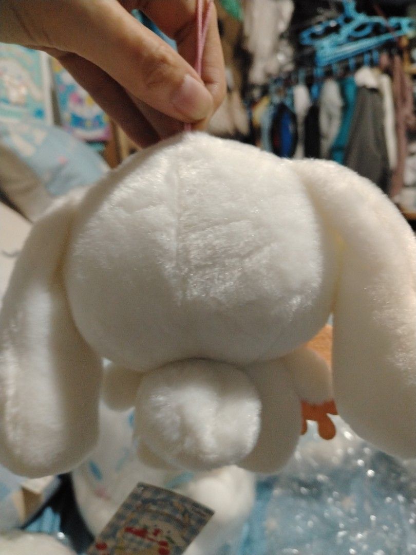 Sanrio Cinnamoroll Plush Toy with Bear Accessory (Category: Plushies & Soft Toys) located in Manila. Submitted by joycechua439850 (Listing ID 1468995457, Image 3). Description: - 100% Official Sanrio Cinnamoroll plush toy - Super soft all-over white fur with cute blue embroidered eyes and pink cheeks - Holding an adorable small felt bear with a blue bowtie - Includes original hang tags (blue and white checkered pattern with Cinnamoroll graphics) 