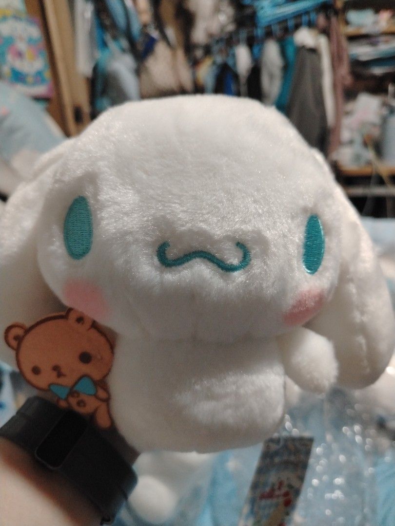 Sanrio Cinnamoroll Plush Toy with Bear Accessory (Category: Plushies & Soft Toys) located in Manila. Submitted by joycechua439850 (Listing ID 1468995457, Image 1). Description: - 100% Official Sanrio Cinnamoroll plush toy - Super soft all-over white fur with cute blue embroidered eyes and pink cheeks - Holding an adorable small felt bear with a blue bowtie - Includes original hang tags (blue and white checkered pattern with Cinnamoroll graphics) 