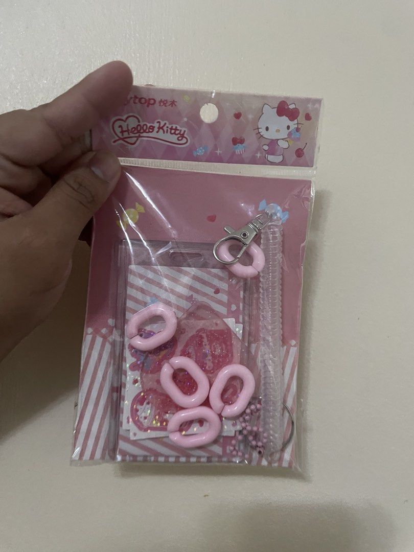 Sanrio Hello Kitty DIY Card Holder Set Pink (Category: Wallets & Card holders) located in Quezon City. Submitted by lianas_preloved (Listing ID 1469040577, Image 1). Description: - Authentic Sanrio x Joytop Kitty DIY card holder set (2023 release) - Color: Cute pink theme - Condition: Brand new, factory sealed - Perfect for ID decoration and photocard collecting - Set includes: Plastic card case, decorative stickers, spring coil rope, plastic cli