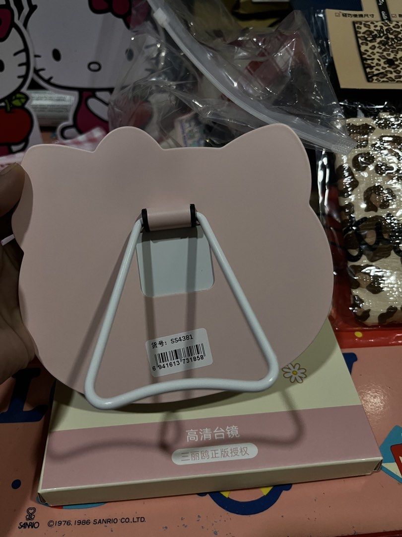 Sanrio Hello Kitty Pink Desktop Mirror with Stand (Category: Mirrors) located in Manila. Submitted by janetecson05 (Listing ID 1468977466, Image 2). Description: - Authentic Sanrio Kitty shaped desktop mirror - Features a sturdy white foldable stand for easy tabletop setup - Comes with the original floral graphics box - Official Sanrio licensed merchandise - Perfect vanity accessory and gift for Kitty fans.