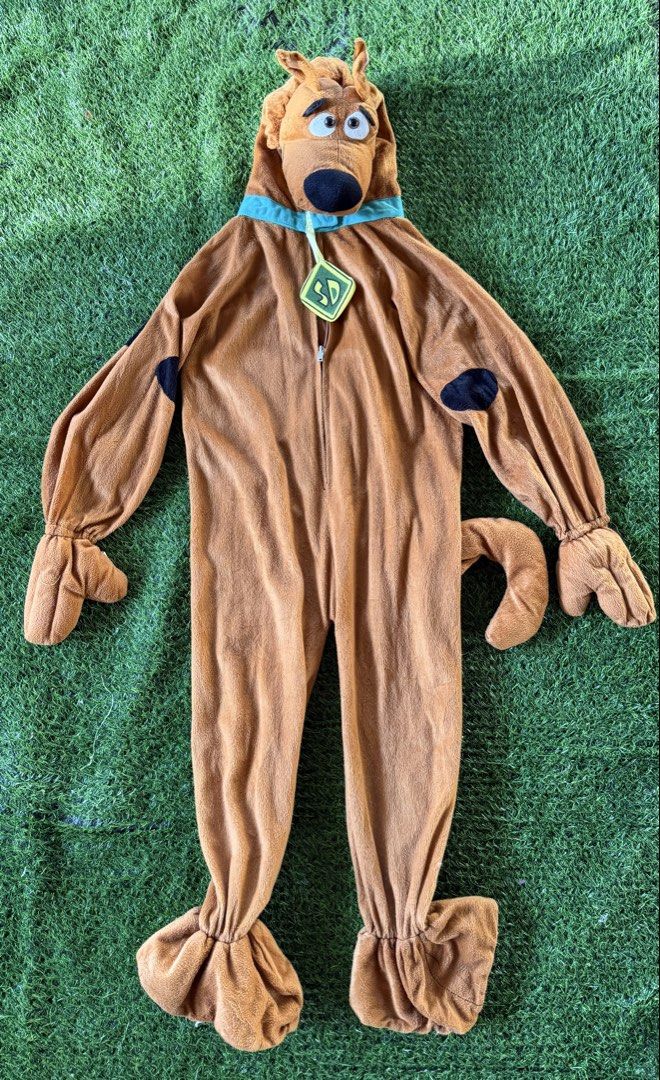 Scooby Doo Costume (Category: Babies & Kids Fashion) located in San Fernando. Submitted by InvisibleMe (Listing ID 1469094298, Image 1). Description: - Authentic Scooby Doo full-body costume - Made from ultra-soft brown plush fleece material - Features attached tail, paws, and character hood - Complete with iconic blue collar and signature diamond tag - Convenient front zipper closure for easy wear - Perfect for Halloween, costume parties, or dre
