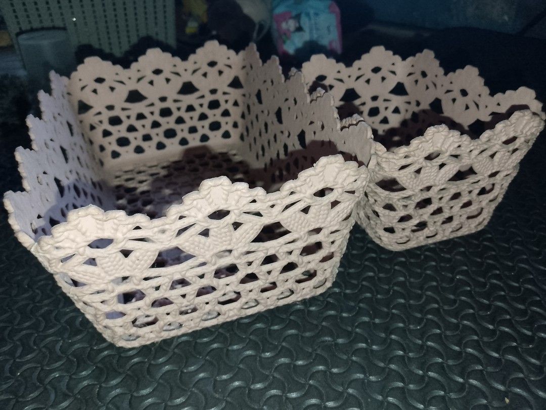 Set of two decorative lace-pattern storage baskets (Category: Storage Boxes & Baskets) located in Manila. Submitted by swiftflower_3827cc (Listing ID 1468979431, Image 1). Description: - Set of 2 plastic storage baskets in different sizes - Cute lace-cut design with stylish scalloped edges - Ideal for organizing vanity items, makeup, stationery, and desk clutter - Lightweight material that is easy to wipe clean - Selling as a set.