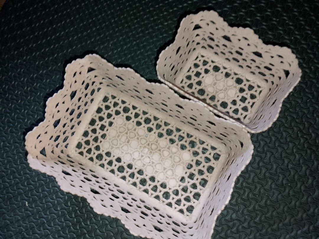 Set of two decorative lace-pattern storage baskets (Category: Storage Boxes & Baskets) located in Manila. Submitted by swiftflower_3827cc (Listing ID 1468979431, Image 2). Description: - Set of 2 plastic storage baskets in different sizes - Cute lace-cut design with stylish scalloped edges - Ideal for organizing vanity items, makeup, stationery, and desk clutter - Lightweight material that is easy to wipe clean - Selling as a set.