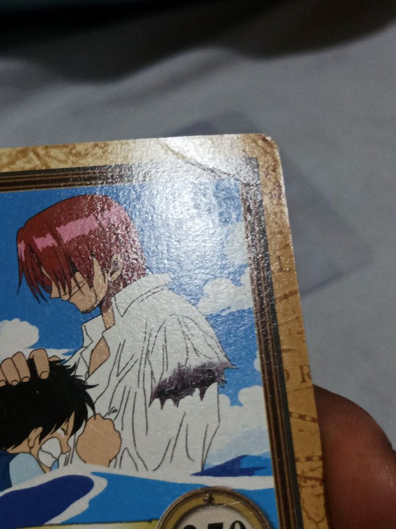 Shanks C122 L (Category: Raw Singles) located in Manila. Submitted by glique30 (Listing ID 1469003605, Image 3). Description: This is a 2000 Bandai One Piece Hyper Battle Carddass card featuring Shanks and Luffy (card number C122, titled "Tomoe no Daishō" or "Price for a Friend" / "Luffy, But Shanks Your Arm!"). May konting yupi sa bandang taas sa Kanang. P1,700 .