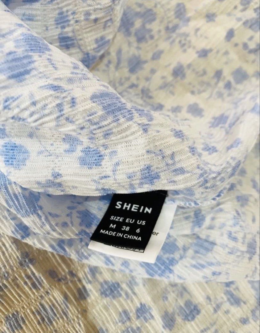 SHEIN Blue Floral Spaghetti Strap Mini Dress Size M (Category: Dresses) located in Marikina City. Submitted by jessylady10 (Listing ID 1468980310, Image 3). Description: - Brand: SHEIN - Style: Blue and white floral mini dress with spaghetti straps and square neckline - Size: Medium (EU 38 / US 6) - Condition: Brand new with tags attached, in original packaging - Material: Lightweight textured fabric - Perfect for: Warm weather, casual outings, a