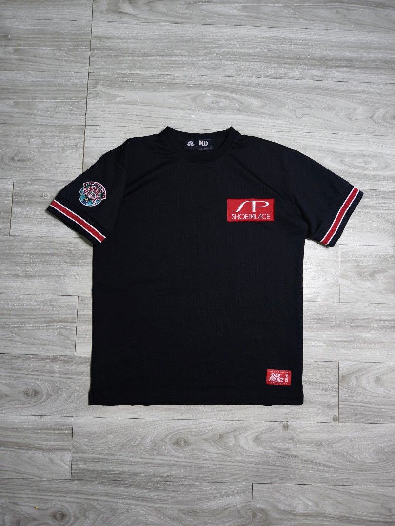 Shoe Palace Athletic Division Jersey (Category: Tshirts & Polo Shirts ) located in Paranaque City. Submitted by pickersform (Listing ID 1469023083, Image 1). Description: - Shoe Palace Athletic Division Jersey - Size: Medium-Large dimes 23x29 - Material: Breathable mesh-like fabric - Design details: Large SP logo patch on left chest, embroidered athletic division patch on right sleeve, and large SP graphic on the back.