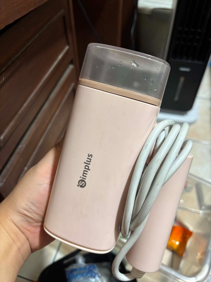 Simplus Portable Garment Steamer Pink (Category: Irons & Steamers) located in Manila. Submitted by cyrineravina (Listing ID 1468977561, Image 2). Description: - Brand: Simplus mini garment steamer - Color: Pastel pink - Condition: Fully functional - Features: Compact size with clear water tank, great for travel and quick touch-ups.