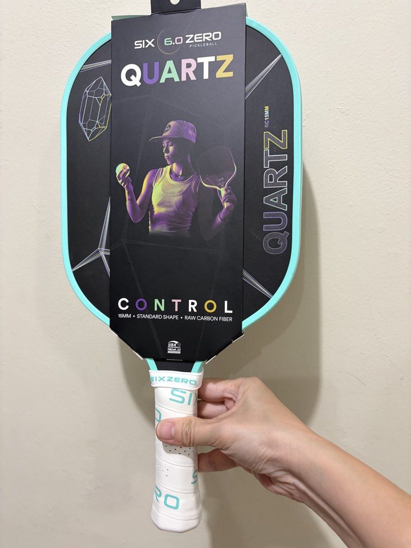 Six Zero Quartz Control Pickleball Paddle 15mm (Category: Racket and Ball Sports) located in Las Pinas. Submitted by bellagirl28 (Listing ID 1468993873, Image 1). Description: - Model: Six Zero Quartz Pickleball Paddle - Condition: Mint, includes original box and packaging - Specs: 15mm thickness, standard shape, control-focused model - Material: Raw carbon fiber face - Design: Black face with crystal geometric graphic and mint green edge guard -