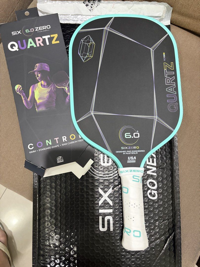 Six Zero Quartz Control Pickleball Paddle 15mm (Category: Racket and Ball Sports) located in Las Pinas. Submitted by bellagirl28 (Listing ID 1468993873, Image 3). Description: - Model: Six Zero Quartz Pickleball Paddle - Condition: Mint, includes original box and packaging - Specs: 15mm thickness, standard shape, control-focused model - Material: Raw carbon fiber face - Design: Black face with crystal geometric graphic and mint green edge guard -