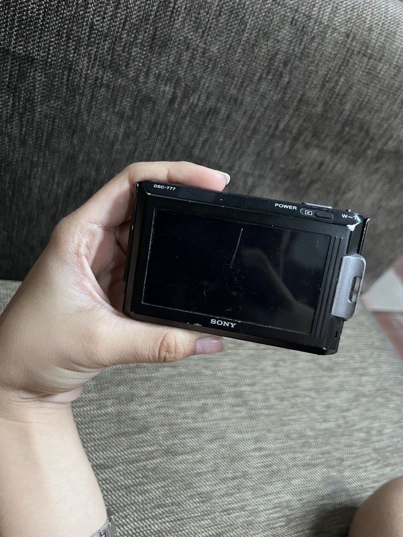 Sony Cyber-shot DSC-T77 Digital Camera (Category: Cameras) located in Manila. Submitted by macinasley96164 (Listing ID 1469056875, Image 2). Description: - Model: Sony Cyber-shot DSC-T77 (Black) - Specs: 10.1 Mega Pixels, 4x Optical Zoom, Optical SteadyShot, and touch screen interface - Features: Full HD still images and smile shutter - Condition: Powers on via top button, zoom works via side control; has scratches on the screen and body from nor