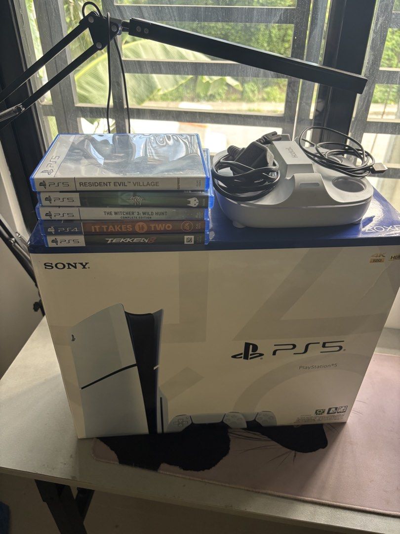 Sony PlayStation 5 Console with Games and Controller with Charging Dock (Category: PlayStation) located in Quezon City. Submitted by getthefrog48943 (Listing ID 1468994376, Image 2). Description: FOR SALE: PS5 Slim Disc Edition Bundle + 2 Controllers, Charging Dock & 5 Games Price: ₱32,000 negotiable Letting go of our well-maintained PS5 Slim Disc Edition as part of decluttering and prioritizing other household expenses. The console is in excelle