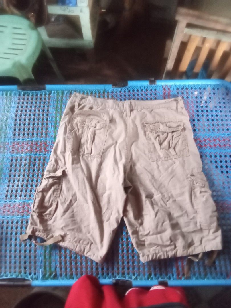 Southpole Cargo Shorts Khaki Size 38 (Category: Shorts) located in Manila. Submitted by boot_tdm (Listing ID 1468707116, Image 3). Description: - Brand: Southpole - Size: 38 - Color: Khaki - Material/Origin: Made in China (RN 82628) - Pockets: Multiple utility pockets on sides and back with button closures - Features: Adjustable drawstrings at the waist and leg openings - Style: Solid everyday casual wear.