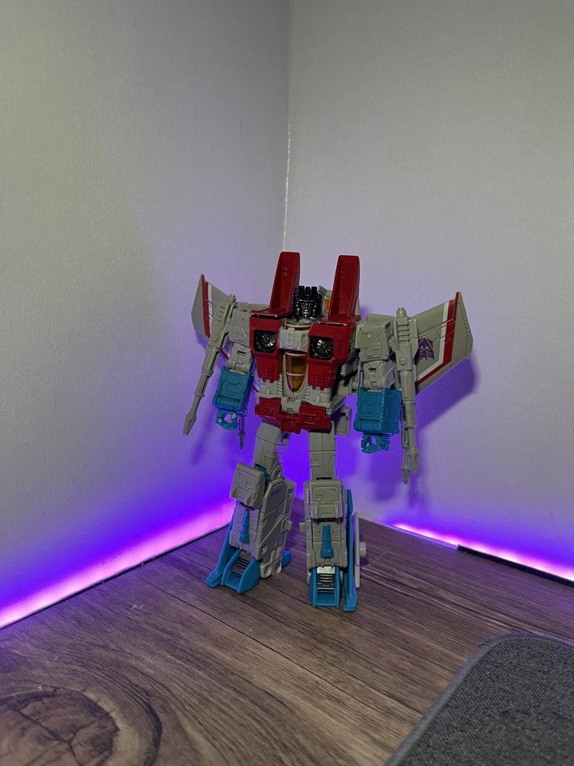 Starscream Coronation (Category: Action & Battle Toys) located in Quezon City. Submitted by renzo__01 (Listing ID 1469003830, Image 1). Description: - Character: Classic Decepticon seeker (robot mode) - Color Scheme: Red, grey, and light blue with Decepticon wing insignia - Articulation: Fully articulated joints for dynamic posing - Condition: Missing weapon accessories - Ideal For: Transformers fans and toy collectors.
