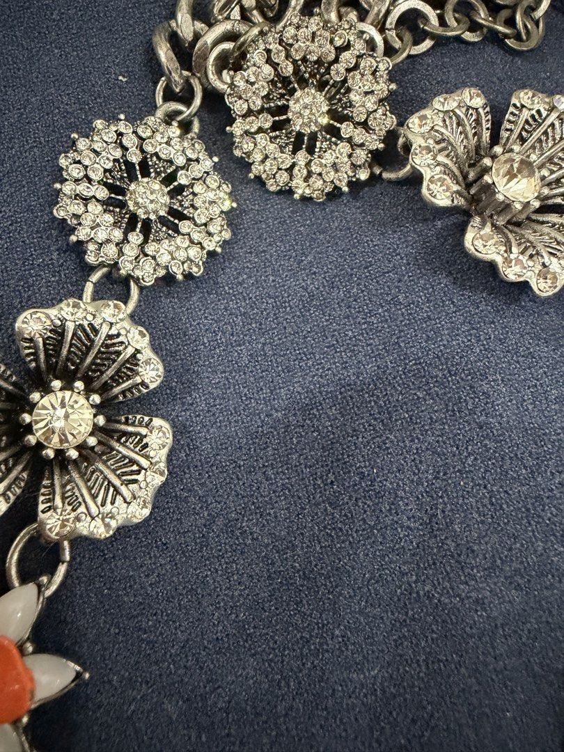 Statement Floral Rhinestone Bib Necklace (Category: Necklaces) located in Makati City. Submitted by petite_preloved2 (Listing ID 1469050800, Image 3). Description: - No missing stones - Eye-catching floral bib necklace with orange, turquoise, and white enamel flowers - Accented with sparkling rhinestone silver flowers and intricate filigree charms - Features a trendy chunky chain link at the top - Adds a vibrant pop of color to plain tops and dre