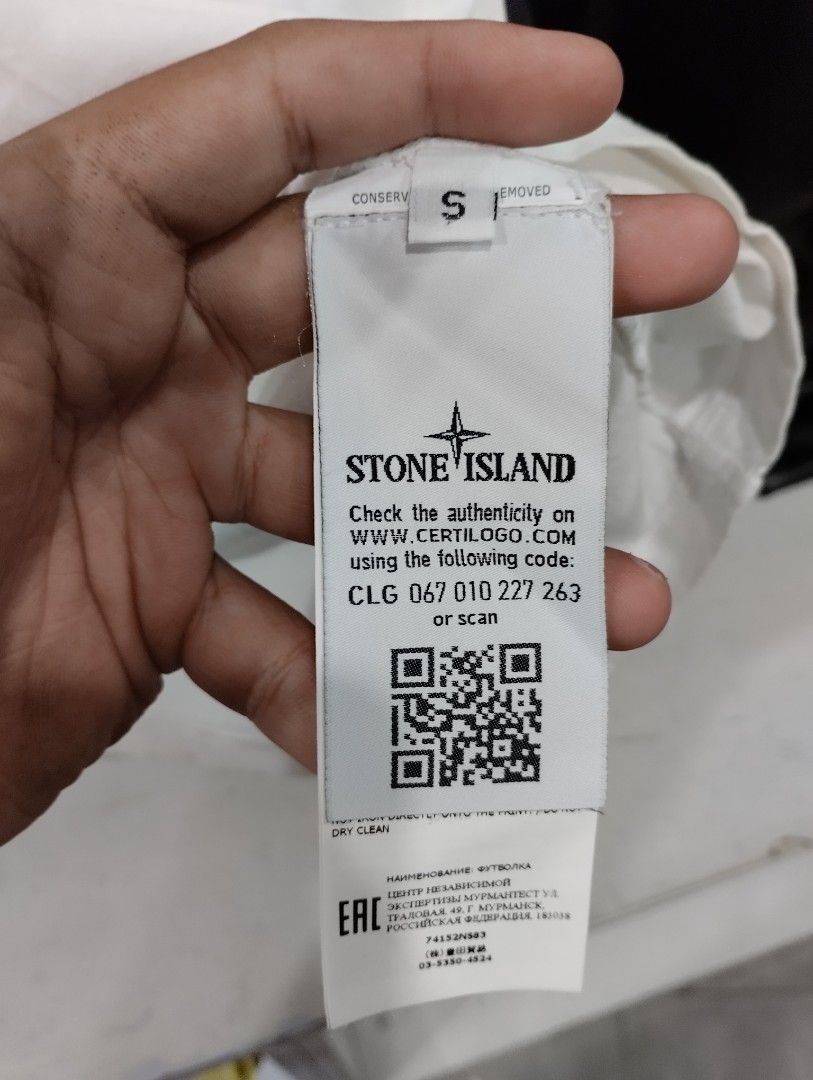 Stone Island White Compass Graphic T-Shirt Size S (Category: Tshirts & Polo Shirts ) located in Manila. Submitted by niggzreyno51476 (Listing ID 1469082012, Image 3). Description: - Brand: Stone Island - Color: White - Size: Men's Small - Design: Large compass graphic print with yellow and grey distressing details on the front - Details: Classic crew neck with black interior striped taping and straight hem - Material: Clean, comfortable cotton fa