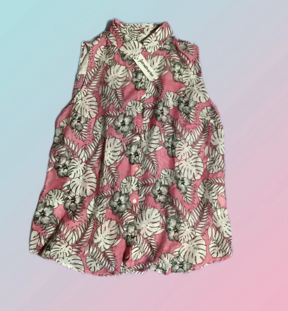 Stradivarius Floral Sleeveless Button-Up Shirts (Category: Sleeveless) located in Paranaque City. Submitted by calm_youngstore7 (Listing ID 1469038018, Image 2). Description: - Brand: Stradivarius - sleeveless button-up shirts - Design 1: Pink base with tropical leaf prints and flowers (comes with original tag) - Design 2: Cream background with purple and yellow floral patterns - Features: Collared neckline, curved hem - Fabric: Lightweight, idea