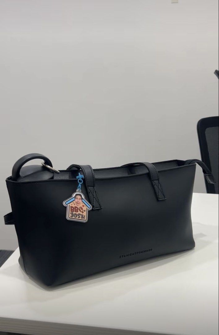 Straightforward Lumi & Miyu (Category: Tote Bags) located in Manila. Submitted by hannahjac (Listing ID 1469020644, Image 2). Description: - Color: Solid black - Design: Clean minimalist tote with embossed front branding - Closure: Secure top zipper - Straps: Dual shoulder straps - take both for 850 pesos.
