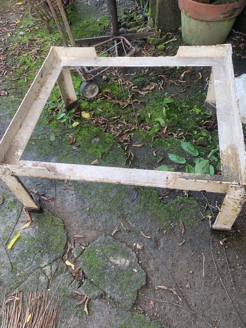 Sturdy metal stand frame for heavy equipment (Category: Construction Tools & Equipment) located in Quezon City. Submitted by sojisup (Listing ID 1468983778, Image 3). Description: Heavy-duty metal stand frame painted off-white. Square shape with four thick legs and corner cutouts on top. Paint is chipped and rusted in multiple spots from outdoor storage. Solid steel construction, weighs quite a bit. Great base for a custom table, planter, or work