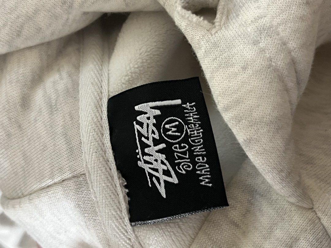 Stussy (Category: Coats, Jackets and Outerwear) located in Paranaque City. Submitted by saxii (Listing ID 1468965809, Image 3). Description: - Brand: Stussy Seoul dupe replica - Color: Light Grey Heather - Condition: 9.5/10 (worn a couple times, no stains or flaws) - Material: Heavyweight fleece, super cozy - Features: Classic chest logo, giant back hit logo, front kangaroo pocket, drawstring hood, ribbed cuffs and hem - Meetups and shipping avai