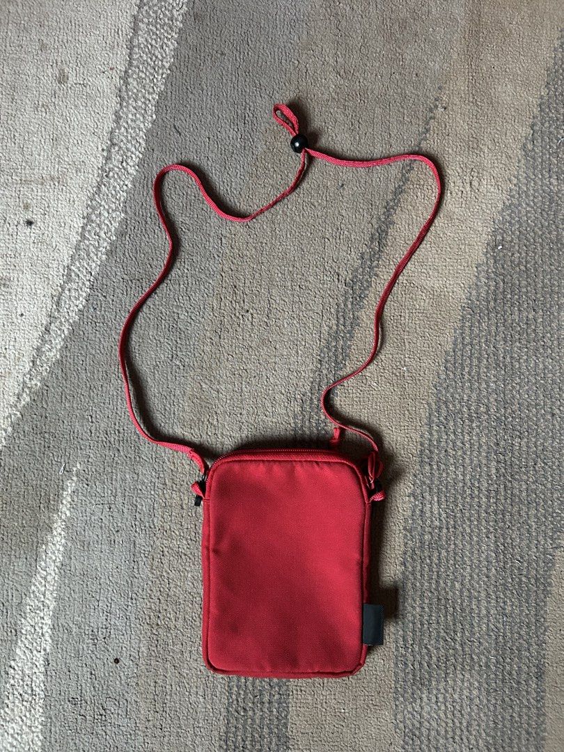 Supreme Red Cordura Utility Pouch Bag (Category: Sling Bags) located in Abucay. Submitted by stuttt (Listing ID 1468995667, Image 2). Description: - Brand: Supreme - Color: Vibrant bright red - Material: Durable Cordura fabric - Features: Clear ID window pocket, secure zippered main compartment, and adjustable cord strap with toggle lock - Origin: Made in China label inside - Condition: Clean, well-maintained, with no major flaws - Perfect for: H