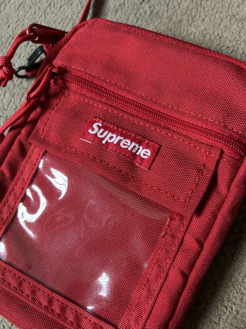 Supreme Red Cordura Utility Pouch Bag (Category: Sling Bags) located in Abucay. Submitted by stuttt (Listing ID 1468995667, Image 3). Description: - Brand: Supreme - Color: Vibrant bright red - Material: Durable Cordura fabric - Features: Clear ID window pocket, secure zippered main compartment, and adjustable cord strap with toggle lock - Origin: Made in China label inside - Condition: Clean, well-maintained, with no major flaws - Perfect for: H