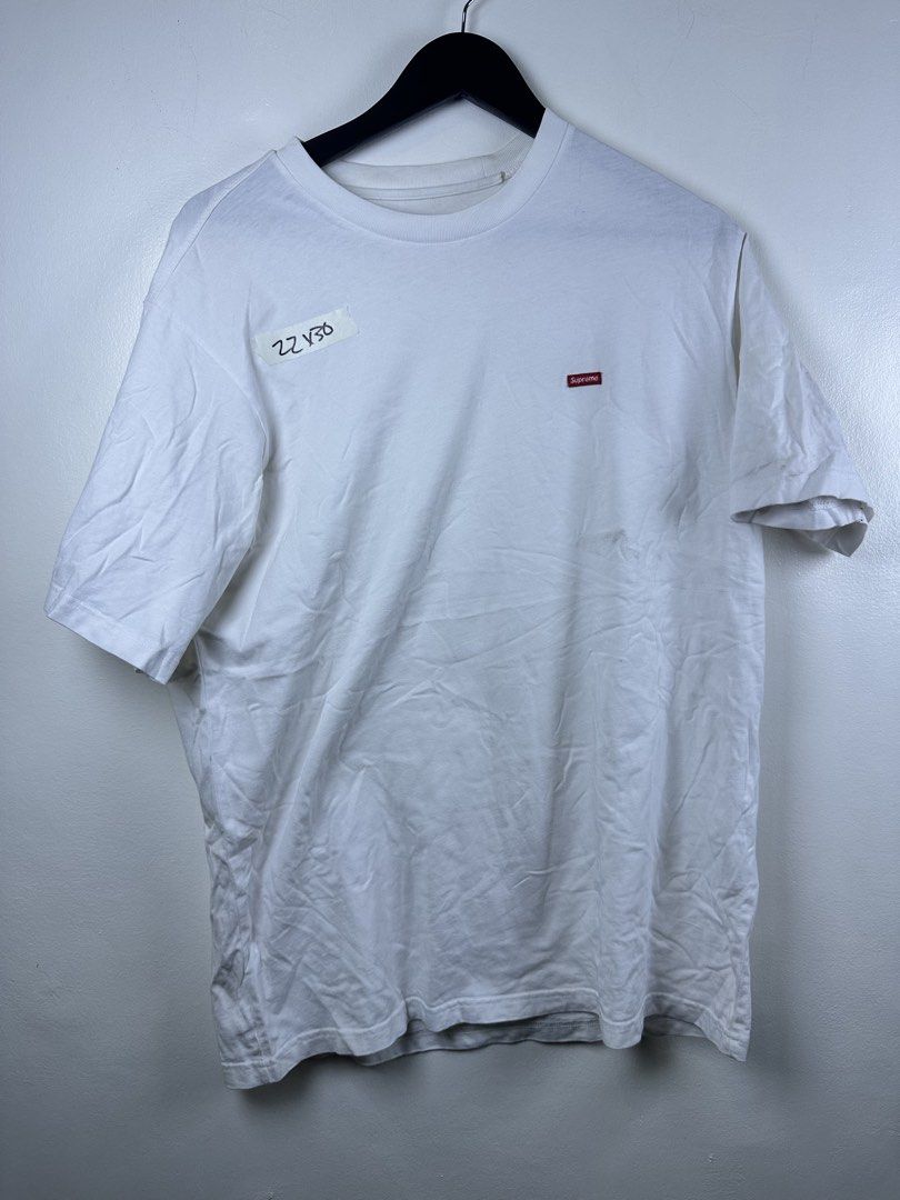 Supreme Small Box Logo White T-Shirt (Category: Tshirts & Polo Shirts ) located in Manila. Submitted by declutterpromax (Listing ID 1468995825, Image 1). Description: - Brand: Supreme - Color: White with small red embroidered box logo - Style: Crew neck, short sleeves - Condition: Pre-owned with general wear and minor storage wrinkling - Flaws: Noticeable grey smudge stain on the lower right front and matching marks on the lower sleeve (please ch