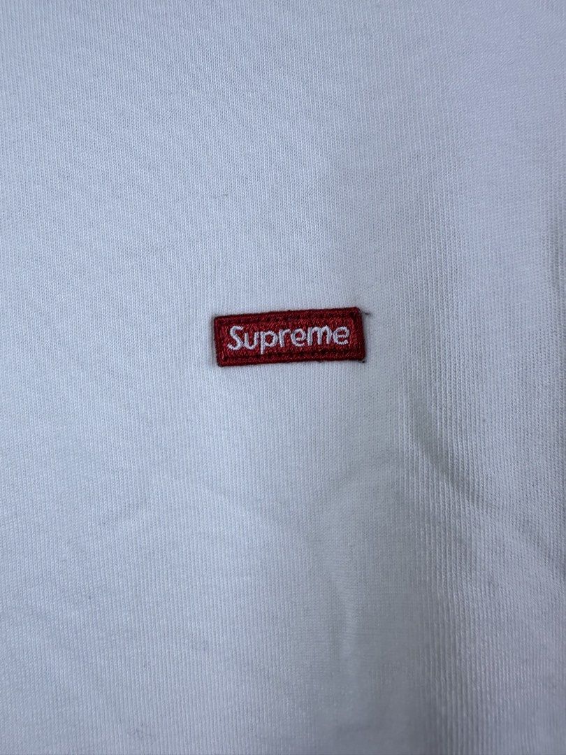 Supreme Small Box Logo White T-Shirt (Category: Tshirts & Polo Shirts ) located in Manila. Submitted by declutterpromax (Listing ID 1468995825, Image 2). Description: - Brand: Supreme - Color: White with small red embroidered box logo - Style: Crew neck, short sleeves - Condition: Pre-owned with general wear and minor storage wrinkling - Flaws: Noticeable grey smudge stain on the lower right front and matching marks on the lower sleeve (please ch