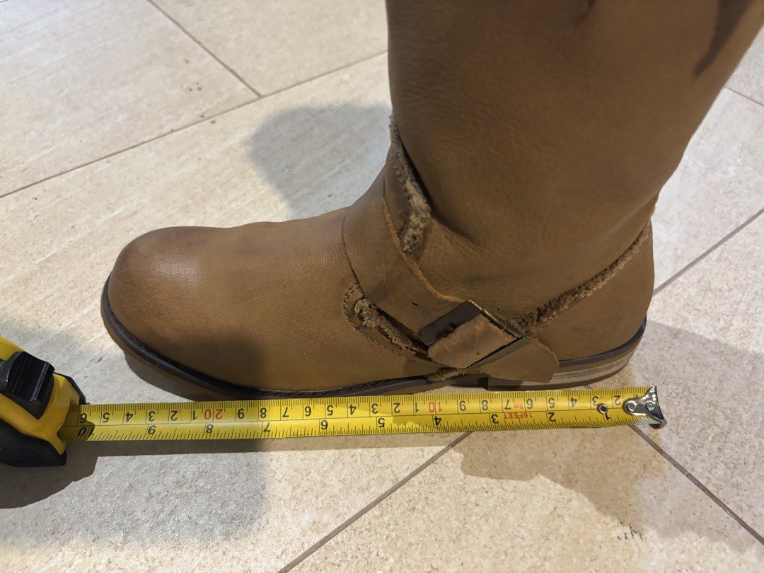Tan Mid-Calf Leather Buckle Boots (Category: Boots) located in Paranaque City. Submitted by maishoppe17 (Listing ID 1468998388, Image 3). Description: - Women's boots - Bought in Bangkok - Mid-calf pull-on boots - Genuine Tan leather with frayed fabric collar trim - Dual buckle straps and elastic side gore panel (easy slip on) - Low heel with rubber grip - Rounded toe for comfort - Rubber sole in mint condition.