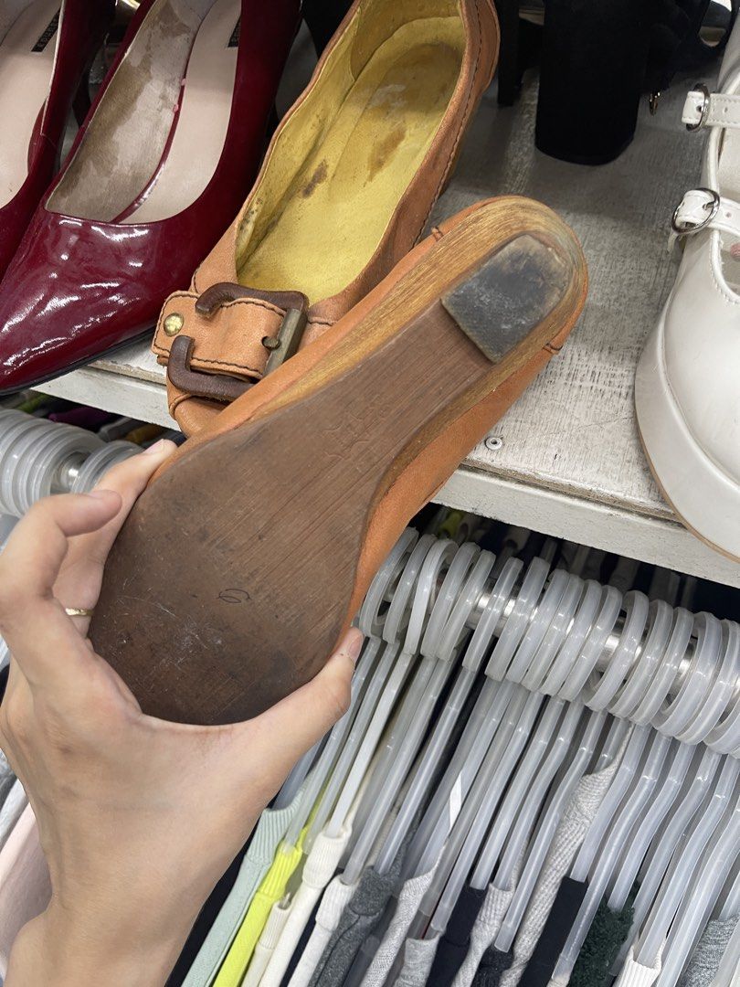 Tan Wedge Heels with Buckle Detail (Category: Heels) located in Balanga. Submitted by crowjo (Listing ID 1469060196, Image 3). Description: - Style: Slip-on peep-toe wedge heels - Color: Tan upper with a cheerful yellow inner lining - Details: Decorative buckle strap across the front - Heel & Sole: Wooden wedge heel with a rubber heel tap for added traction - Condition: Minor wear marks on the yellow inner lining, but otherwise in good, wearable 