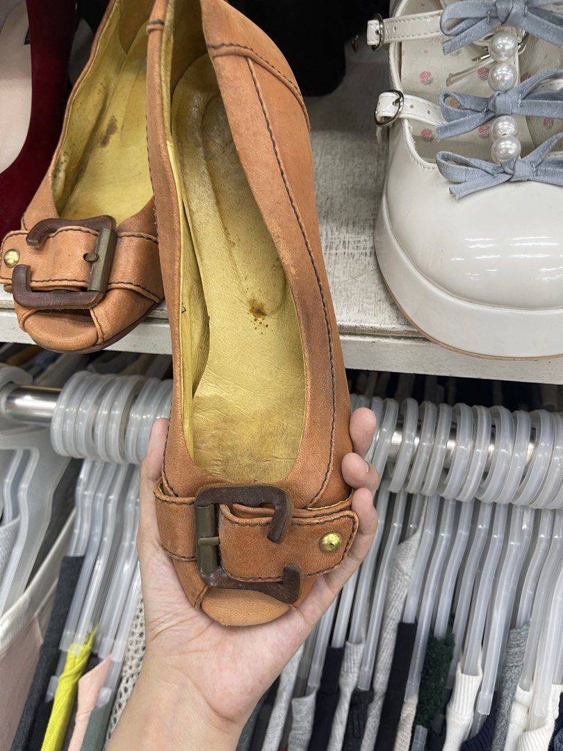 Tan Wedge Heels with Buckle Detail (Category: Heels) located in Balanga. Submitted by crowjo (Listing ID 1469060196, Image 1). Description: - Style: Slip-on peep-toe wedge heels - Color: Tan upper with a cheerful yellow inner lining - Details: Decorative buckle strap across the front - Heel & Sole: Wooden wedge heel with a rubber heel tap for added traction - Condition: Minor wear marks on the yellow inner lining, but otherwise in good, wearable 