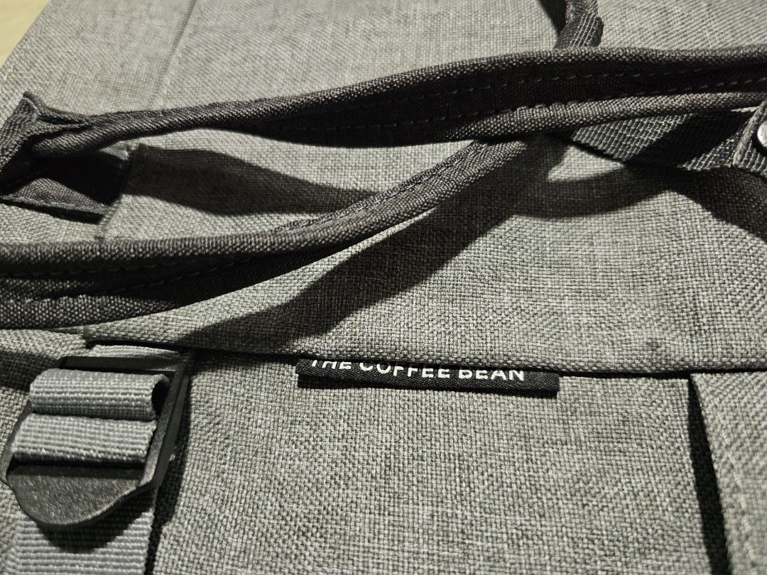 The Coffee Bean Grey Convertible Tote Backpack (Category: Backpacks) located in Dasmarinas. Submitted by jazvielle (Listing ID 1469086987, Image 2). Description: Grey canvas backpack from The Coffee Bean. Converts easily between a tote bag and a backpack with adjustable straps. Exterior front pocket with logo patch and zipper closure. Spacious main compartment inside lined in grey fabric. Clean inside and out, minor wear overall. Great everyday b
