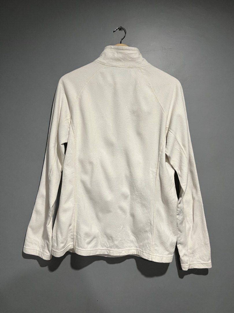 The North Face White Quarter-Zip Fleece Pullover (Category: Coats, Jackets and Outerwear) located in Maasin. Submitted by niconii090 (Listing ID 1468985333, Image 2). Description: - Brand: The North Face - Color: White - Style: Half-zip fleece pullover with mock neck and kangaroo pocket - Extra Features: Thumbholes on sleeves with zippered cuffs, embroidered chest logo - Condition: Pre-loved with a couple of small stains on the fabric and sleeve 