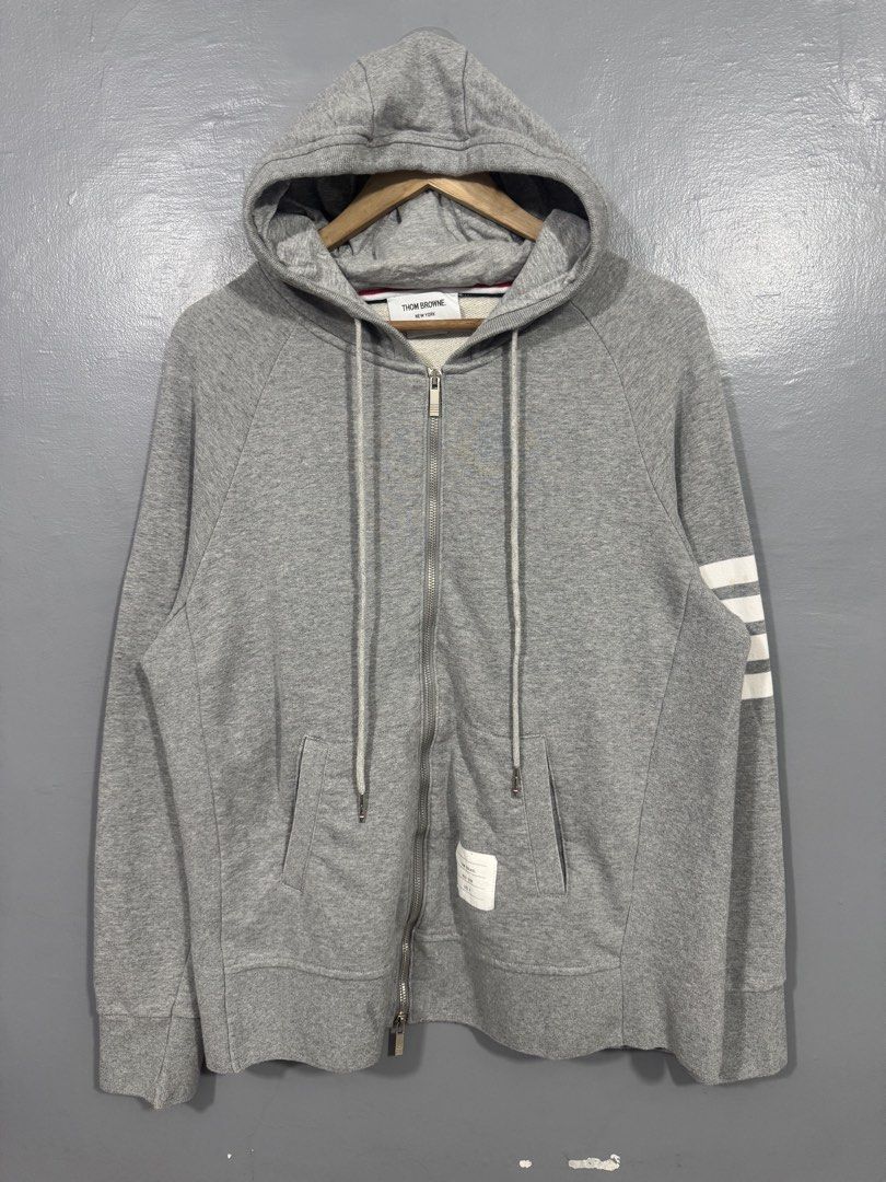 Thom Browne 4-Bar Zip-up Hoodie (Category: Hoodies) located in Manila. Submitted by sophisticatedgoons (Listing ID 1468940995, Image 3). Description: Thom Browne 4-Bar Zip-up Hoodie Size: Medium - Large men's Dimes: 22 x 27 In good condition Issue: 2 yellow stain in arm bar (see last pic) Presentable.