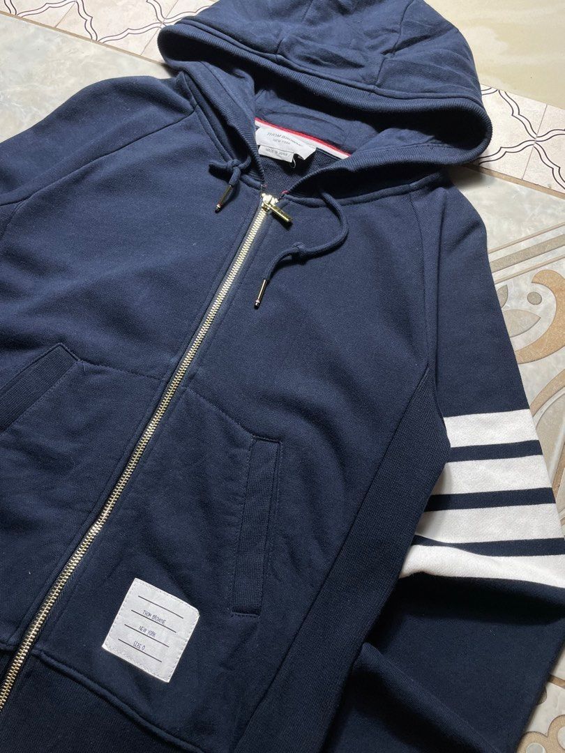 Thom Browne Classic Loopback 4-Bar Zip-Up Hoodie Navy Blue (Category: Coats, Jackets and Outerwear) located in Caloocan City. Submitted by renowear (Listing ID 1469100077, Image 2). Description: Thom Browne Classic Loopback 4-Bar Zip-Up Hoodie Navy Blue As New Condition Color Rate: 9.8/10 No Issue Measurements • Width: 19 • Length: 24.5 Price: 1500 obo DM IF INTERESTED📥.