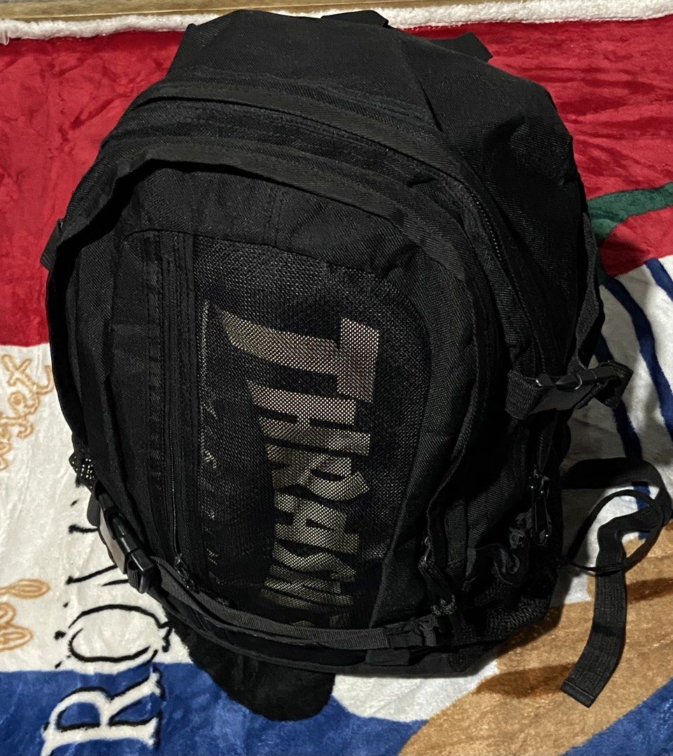 Thrasher Magazine Skate and Destroy Black Backpack (Category: Backpacks) located in Polomolok. Submitted by tnecniv311 (Listing ID 1469101573, Image 3). Description: - Brand: Thrasher - Color: Classic Black - Design: Large branded logo on front mesh pocket and Thrasher branding on front buckle strap - Storage: Multiple zipped compartments and convenient mesh side pockets - Special Feature: Inside tag includes the iconic 'Skate and Destroy' graphi