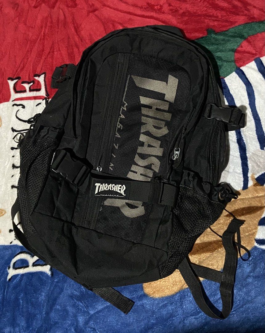 Thrasher Magazine Skate and Destroy Black Backpack (Category: Backpacks) located in Polomolok. Submitted by tnecniv311 (Listing ID 1469101573, Image 1). Description: - Brand: Thrasher - Color: Classic Black - Design: Large branded logo on front mesh pocket and Thrasher branding on front buckle strap - Storage: Multiple zipped compartments and convenient mesh side pockets - Special Feature: Inside tag includes the iconic 'Skate and Destroy' graphi