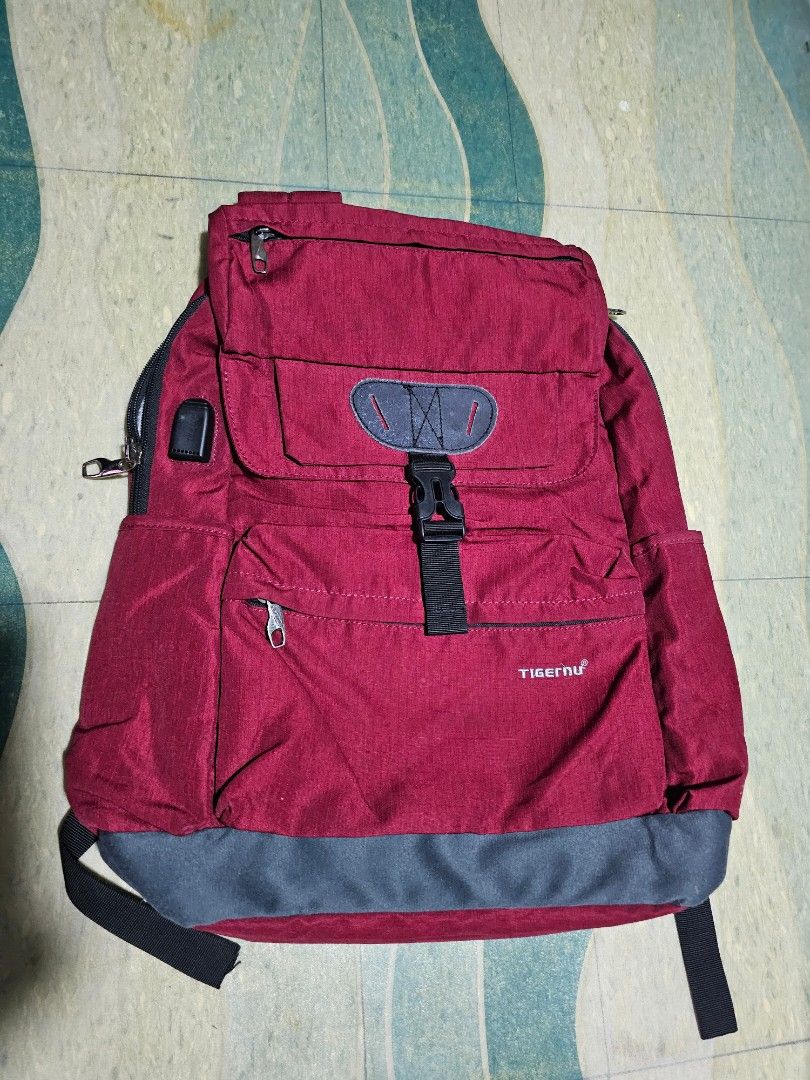 Tigernu Red Grey Laptop Backpack (Category: Backpacks) located in Dasmarinas. Submitted by jazvielle (Listing ID 1469085859, Image 1). Description: - Brand: Tigernu - Color: Red and Grey - Size: Roughly 16 to 17 inches - Laptop Compartment: Spacious main area with a secure velcro strap - Organization: Multiple zippered compartments and front pocket with built-in card slots and pen loops - Comfort & Durability: Durable fabric construction with adj