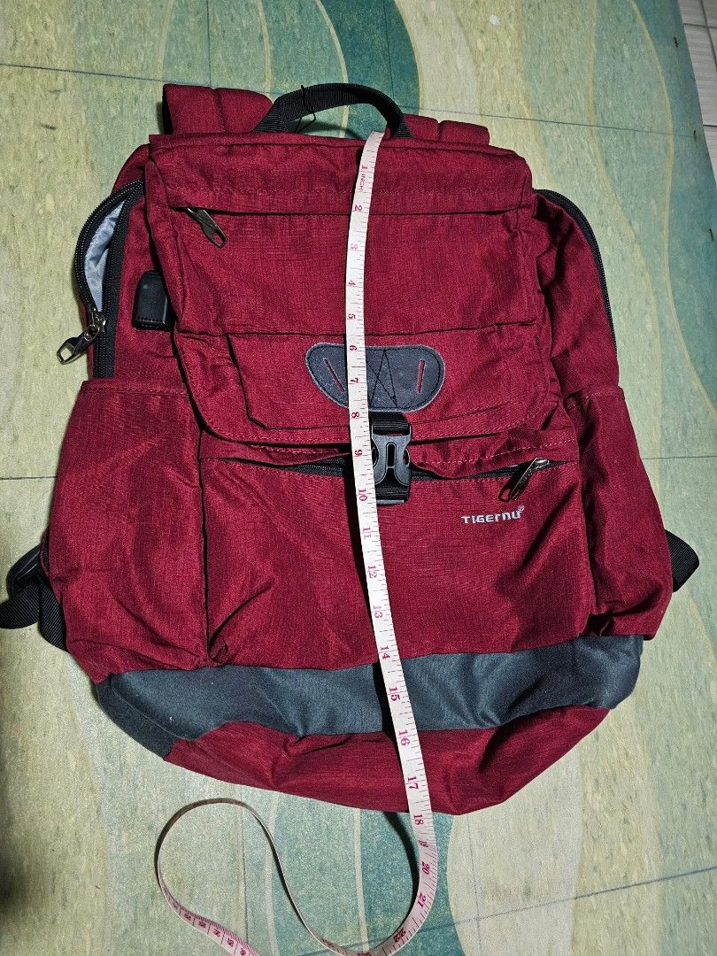 Tigernu Red Grey Laptop Backpack (Category: Backpacks) located in Dasmarinas. Submitted by jazvielle (Listing ID 1469085859, Image 2). Description: - Brand: Tigernu - Color: Red and Grey - Size: Roughly 16 to 17 inches - Laptop Compartment: Spacious main area with a secure velcro strap - Organization: Multiple zippered compartments and front pocket with built-in card slots and pen loops - Comfort & Durability: Durable fabric construction with adj