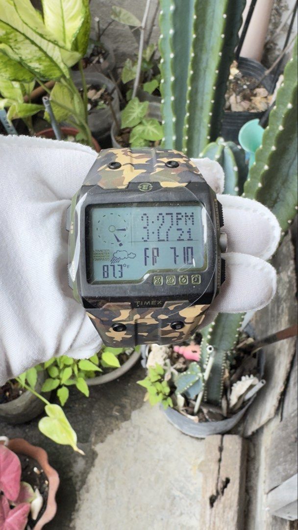 Timex Expedition WS4 Camouflage Digital Watch (Category: Men's Watches) located in Manila. Submitted by junjun12356 (Listing ID 1469160281, Image 1). Description: - Brand: Timex Expedition - Style: Rugged outdoor tactical digital watch - Display: Square digital screen with time, weather icons, and temperature reading (87.3°F) - Design: Bold camouflage pattern with olive green strap accents and black buckle - Build: Durable stainless steel case ba
