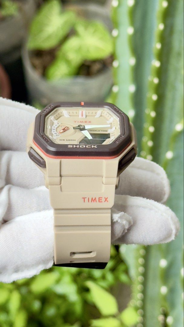 Timex Shock Analog Digital Tan Brown Watch (Category: Men's Watches) located in Manila. Submitted by junjun12356 (Listing ID 1469159383, Image 2). Description: - Brand: Timex Shock - Color: Tan and brown tones - Display: Analog hands with digital window - Strap: Durable resin strap with black buckle closure - Water Resistance: Up to 100 meters - Design: Octagon-shaped bezel with textured side pushers - Condition: Clean, handled with gloves.