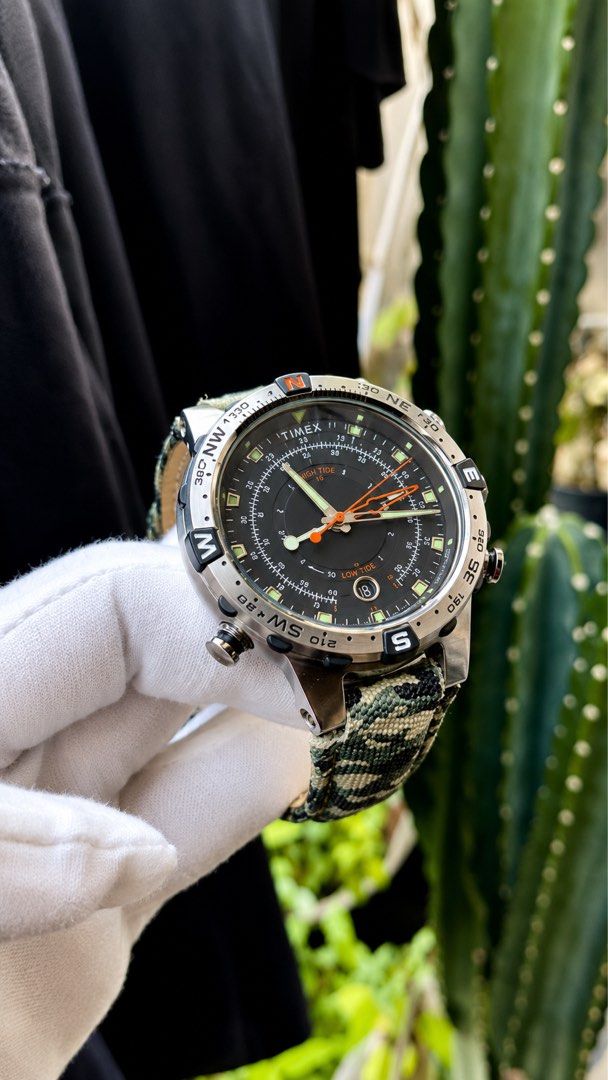 Timex Tide Temp Compass Camo Watch (Category: Men's Watches) located in Manila. Submitted by junjun12356 (Listing ID 1469159323, Image 3). Description: - Brand: Timex - Style: Tactical watch with multi-function black dial - Features: High tide, low tide, compass, and temperature tracking - Case: Stainless steel with multiple crowns/pushers and detailed globe caseback - Strap: Camo fabric with leather backing and signed buckle - Condition: Worn a 