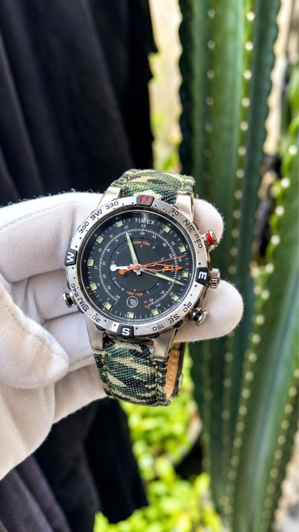Timex Tide Temp Compass Camo Watch (Category: Men's Watches) located in Manila. Submitted by junjun12356 (Listing ID 1469159323, Image 2). Description: - Brand: Timex - Style: Tactical watch with multi-function black dial - Features: High tide, low tide, compass, and temperature tracking - Case: Stainless steel with multiple crowns/pushers and detailed globe caseback - Strap: Camo fabric with leather backing and signed buckle - Condition: Worn a 