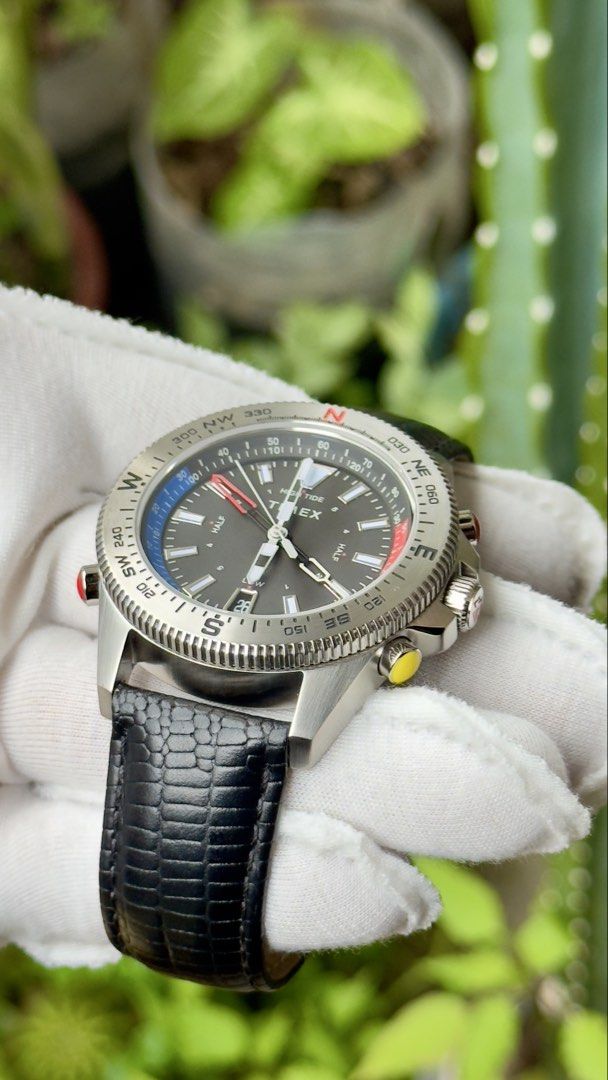 Timex Tide Temp Compass Watch (Category: Men's Watches) located in Manila. Submitted by junjun12356 (Listing ID 1469159421, Image 2). Description: - Brand: Timex - Model: Tide Temp Compass Watch - Dial: Dark grey with date window at 6 o'clock - Case: Stainless steel with multi-function pushers on the right and a red pusher on the left - Bezel: Rotating compass bezel - Strap: Black embossed leather strap with signed Timex buckle - Condition: Excel