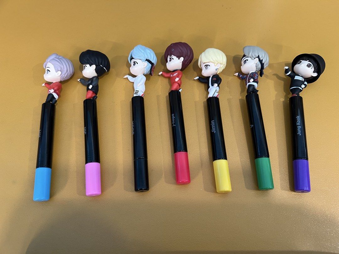 TinyTAN BTS Mic Drop Gel Pen Set with Display Stand (Category: Figurines & Statues) located in Makati City. Submitted by kibookid (Listing ID 1468971089, Image 3). Description: - Complete set of 7 TinyTAN BTS character gel pens - Features RM, Jin, SUGA, j-hope, Jimin, V, and Jung Kook - Matching color caps and ink for each member - Includes a custom display stand with TinyTAN logo - Great collectible item for ARMY - pre loved - ready to ship (fro