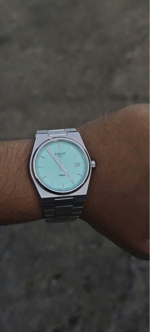 Tissot PRX Mint Green Quartz Watch (Category: Men's Watches) located in Bustos. Submitted by val63 (Listing ID 1469008528, Image 2). Description: - Model: Tissot PRX Quartz - Dial: Mint Green - Bracelet: Stainless steel integrated bracelet with extra links included - Features: Date window at 3 o'clock - Condition: Worn a few times, minimal signs of wear on case and bracelet - Inclusions: Original box, outer packaging, and papers complete.
