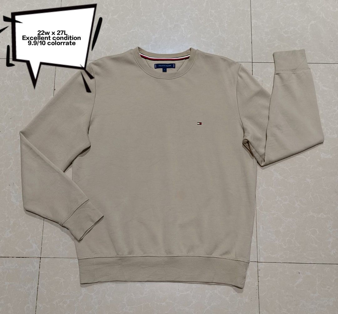 Tommy Hilfiger Beige Sweatshirt Size L (Category: Coats, Jackets and Outerwear) located in Manila. Submitted by purefire-477a (Listing ID 1469078022, Image 1). Description: Tommy Hilfiger crewneck sweatshirt in a clean beige colorway. Size large tag attached at the inner collar with signature red, white, and blue taping. Small embroidered flag logo on the left chest. Ribbed cuffs, hem, and collar keep their shape well. Soft cotton blend material.