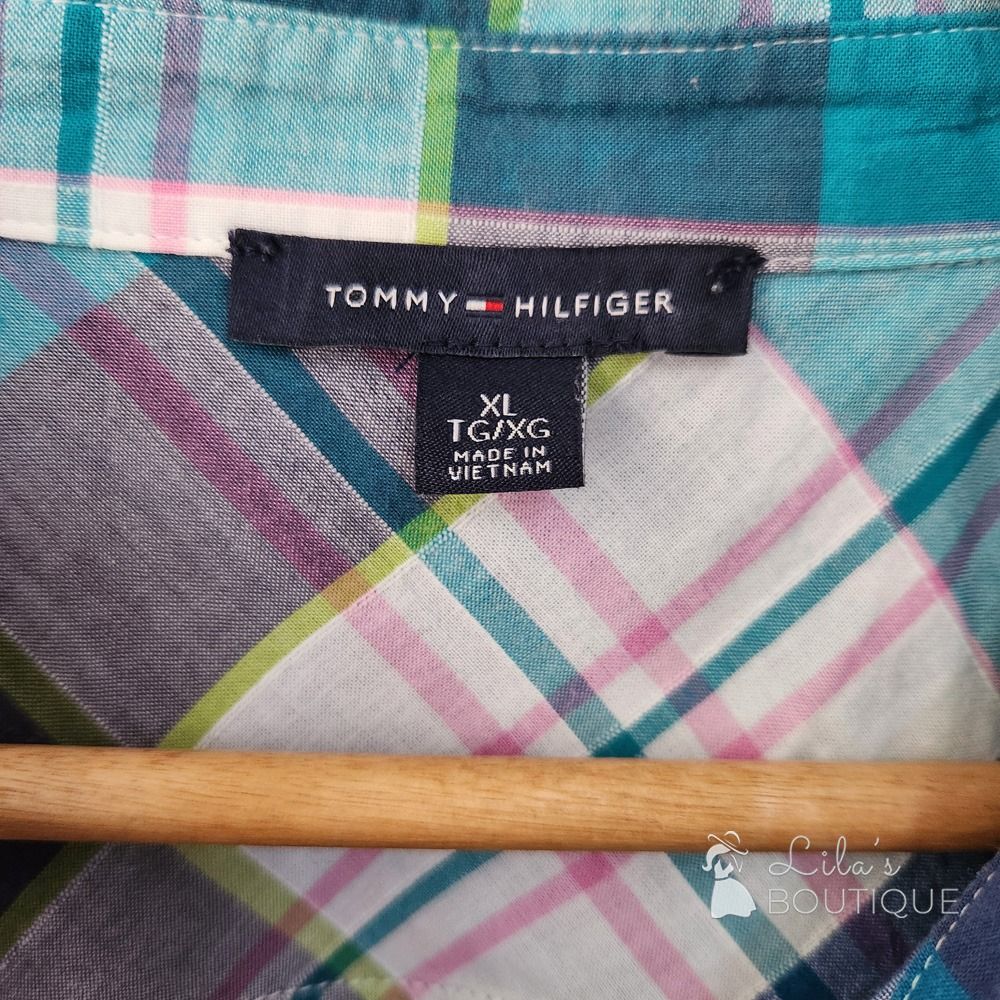 Tommy Hilfiger Plaid Short Sleeve Button Up Top (Category: Blouses) located in San Fernando. Submitted by lilasboutique (Listing ID 1468934537, Image 3). Description: Size: X-LARGE (XL) Chest: 44 in | Length: 26 in Fit: Regular Details: • Great Condition. No issues • Brand: Tommy Hilfiger • Color: Teal, Blue, White, Pink, Grey.