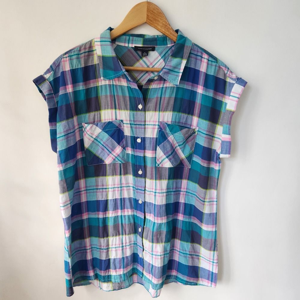 Tommy Hilfiger Plaid Short Sleeve Button Up Top (Category: Blouses) located in San Fernando. Submitted by lilasboutique (Listing ID 1468934537, Image 1). Description: Size: X-LARGE (XL) Chest: 44 in | Length: 26 in Fit: Regular Details: • Great Condition. No issues • Brand: Tommy Hilfiger • Color: Teal, Blue, White, Pink, Grey.