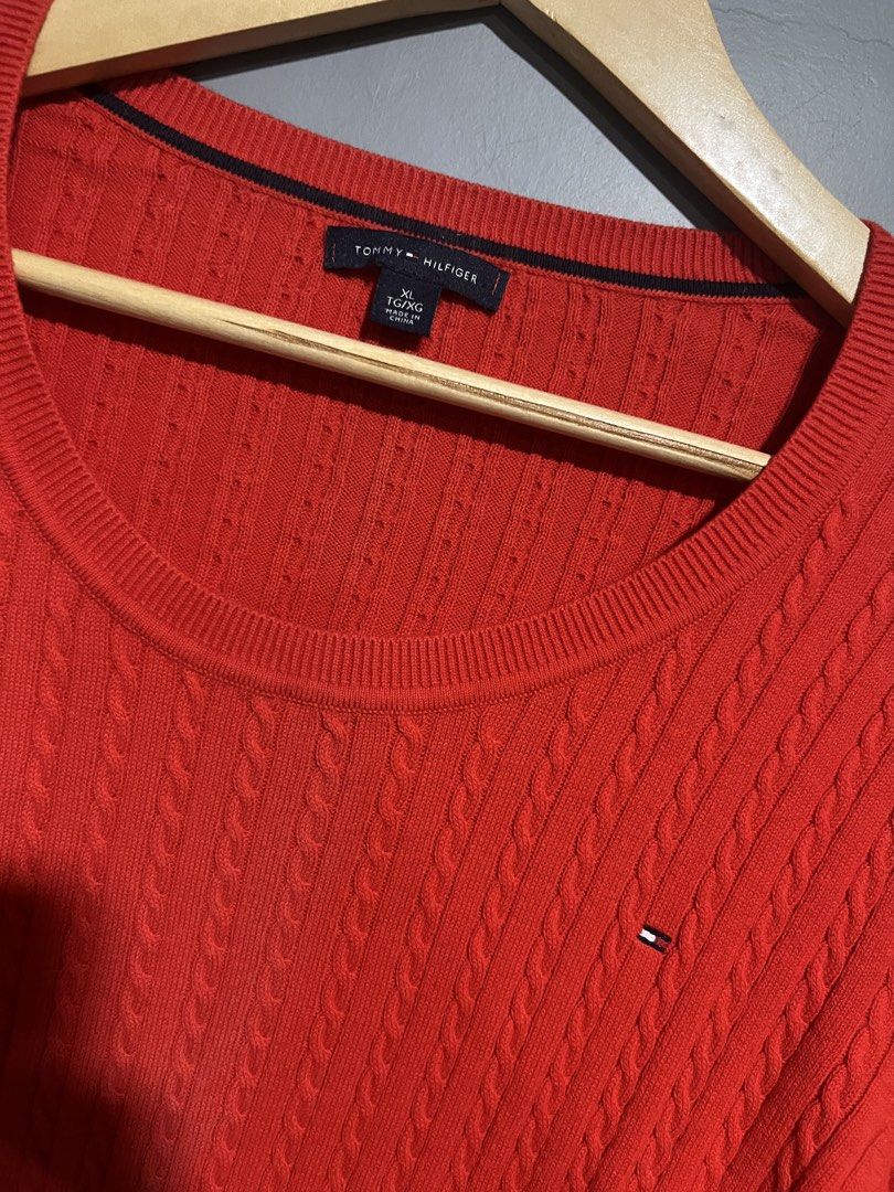 Tommy Hilfiger Red Cable Knit Sweater (Category: Coats, Jackets and Outerwear) located in Maasin. Submitted by niconii090 (Listing ID 1468985629, Image 2). Description: - Brand: Tommy Hilfiger - Style: Cable knit crew neck sweater - Color: Bright red - Details: Long sleeves, ribbed trim, small embroidered flag logo on left chest - Material: Soft cotton knit texture -📏 20 x 26 (inches).